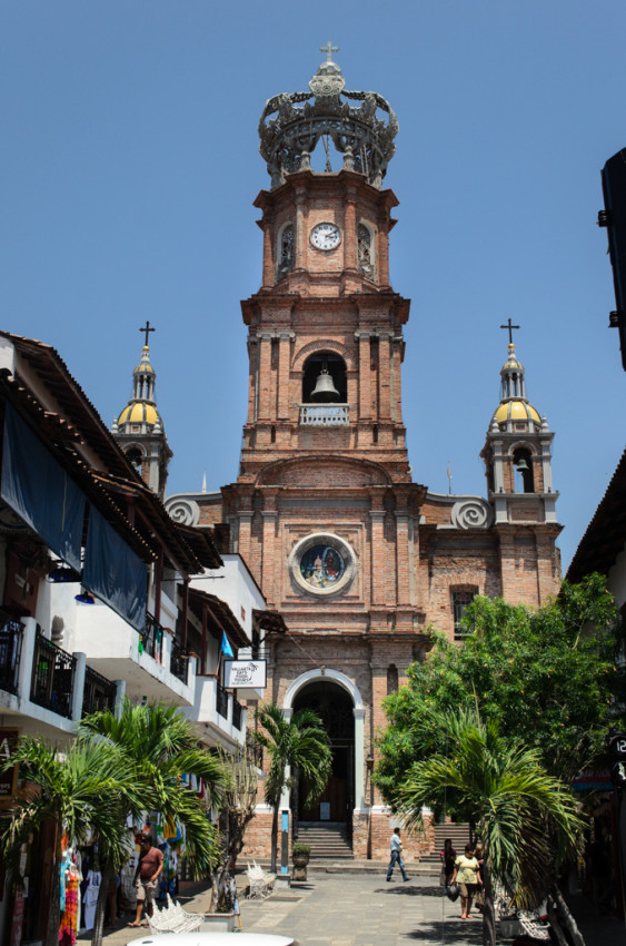 Puerto Vallarta’s Church of Our Lady of Guadalupe. The steel crown at the top of the clock tower was once blown off by a hurricane, and had to be re-mounted. Photo © 2015 Aaron Saunders