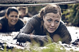 group of women crawling in mud