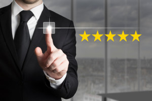 businessman in black suit pushing button five star rating