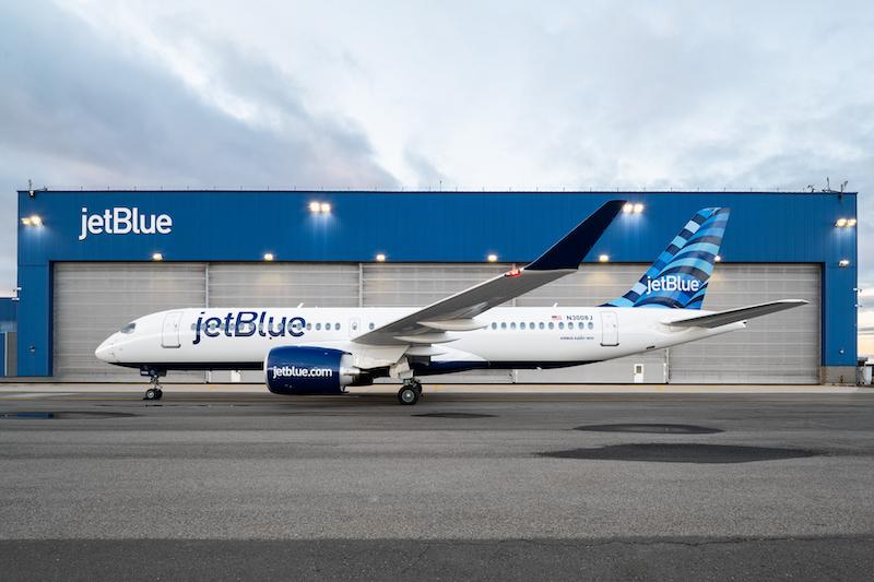 JetBlue A220 in front of hangar