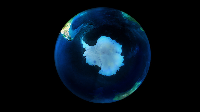 Earth from space on black background showing Antarctica.
