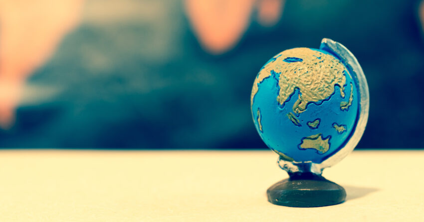 Blue globe against grunge world map