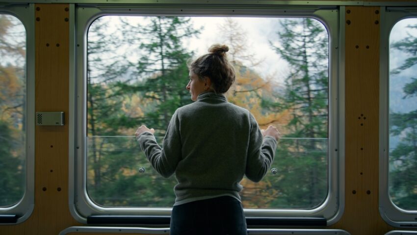 Woman looking out the window of a train