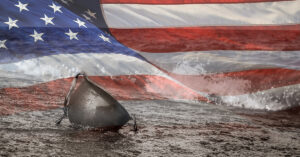 World War 2 helmet on beach with United States flag in background