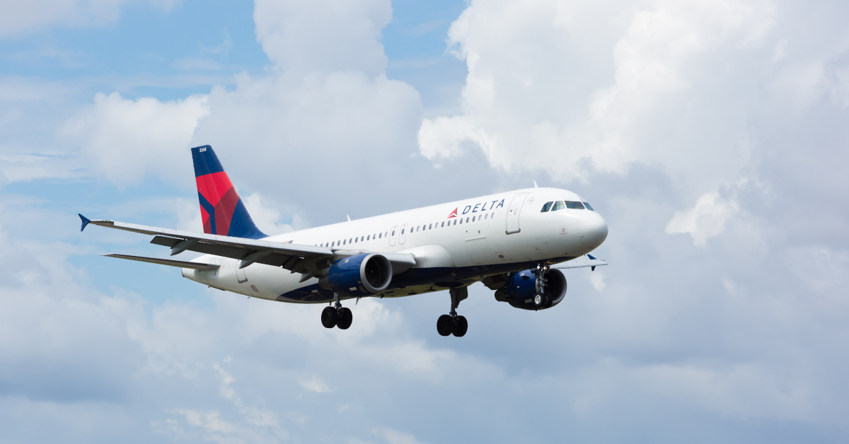 Delta Airlines plane in sky. Adobe Stock.
