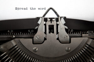 Typewriter with the words "Spread the Word"